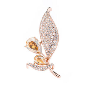 Gold leaf brooch with topaz and diamonds on white background
